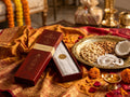 Hands opening the Coconut Silk incense gift box resting on silk fabric