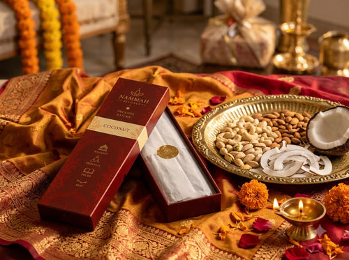 Hands opening the Coconut Silk incense gift box resting on silk fabric